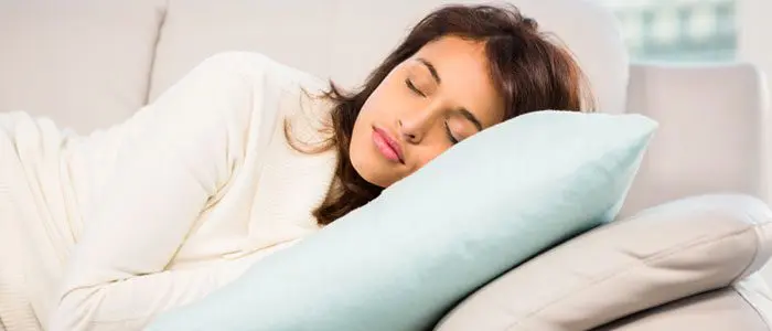 Woman asleep on the sofa on her rest day