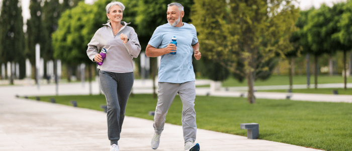 Couple running through park