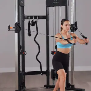 woman using a functional trainer in her home gym