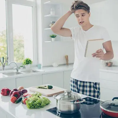 man in the kitchen looking confused