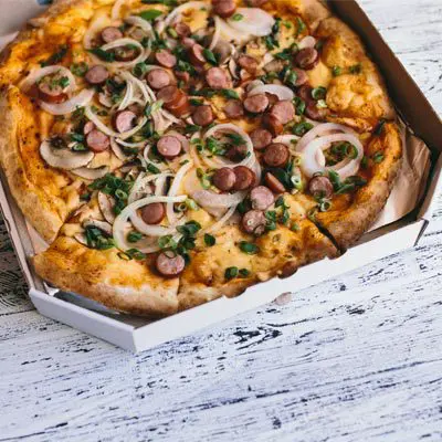 a pizza in a box on the counter