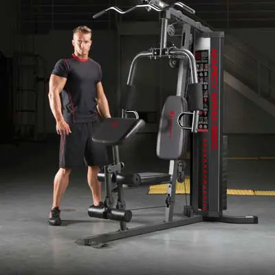person stood next to a marcy multigym