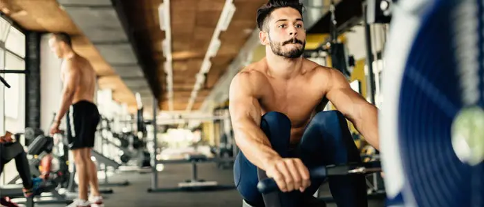 Man using a rowing machine in a gym