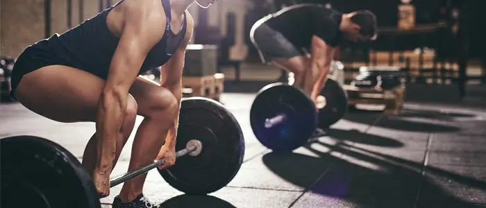 woman and man doing deadlift - halloween workout