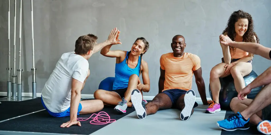group of people celebrating reaching their fitness goals - fitness questions