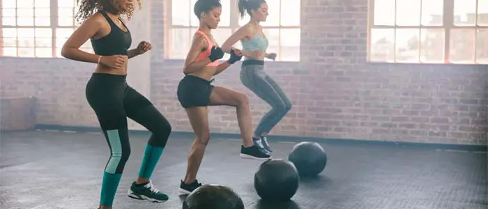 three women training with gym balls