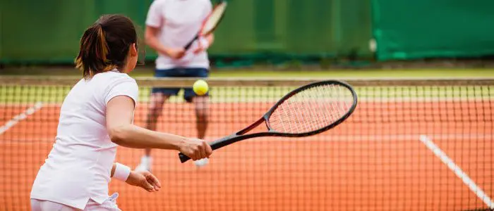 woman playing tennis on a tennis court