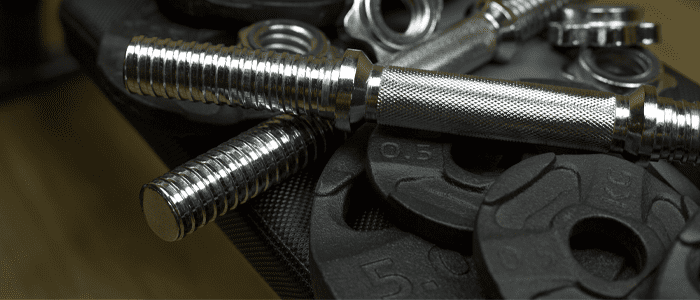 Collection of weights and dumbbell parts that make up adjustable dumbbells