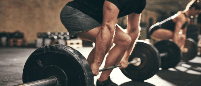 people lifitng weighted barbells